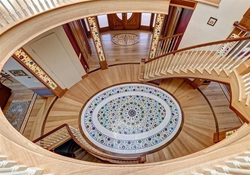 Elegant Staircase With Colorful Oval Floor Medallion